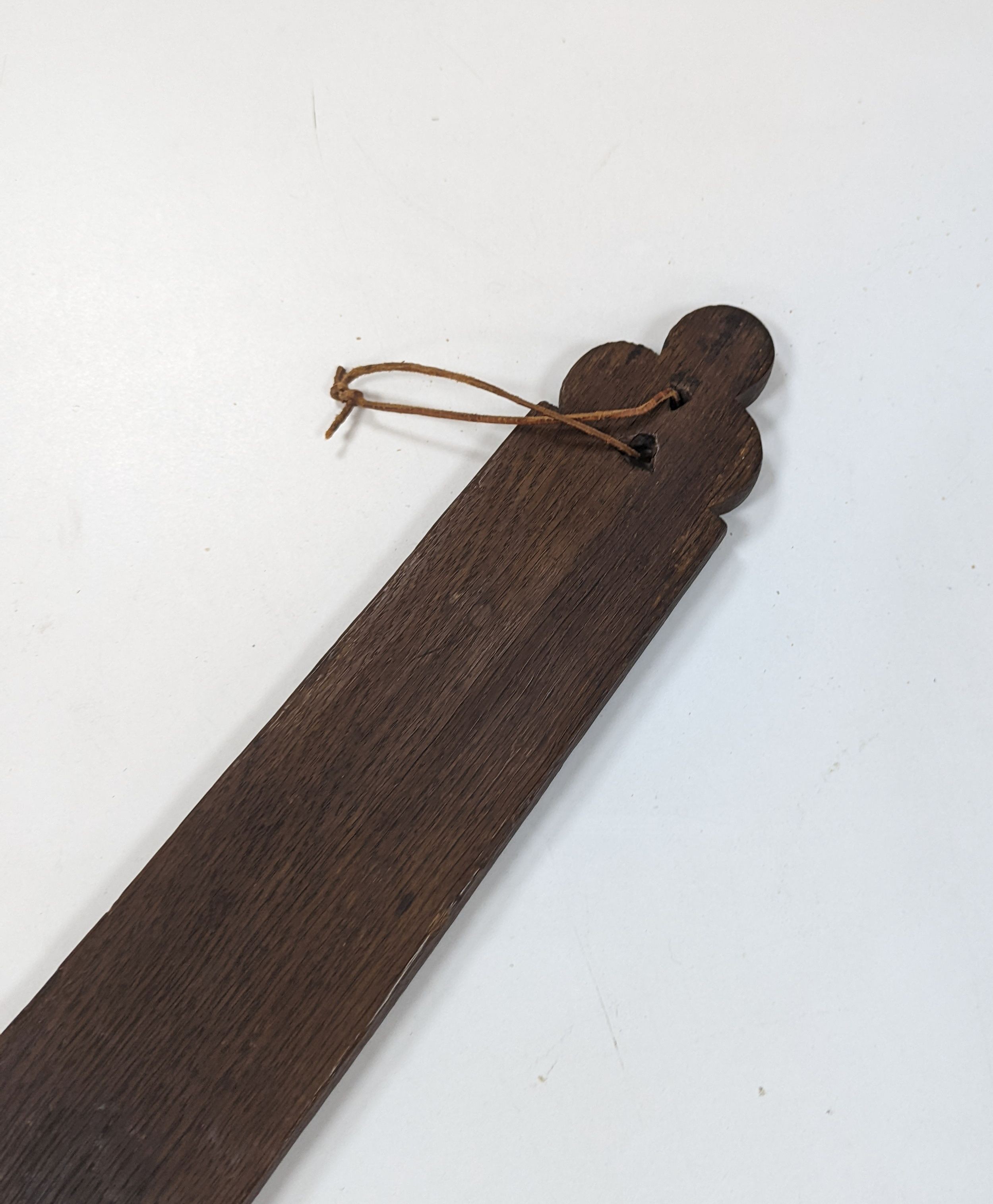 An 18th century Norwegian chip carved oak mangle board, dated 1730, 77cm